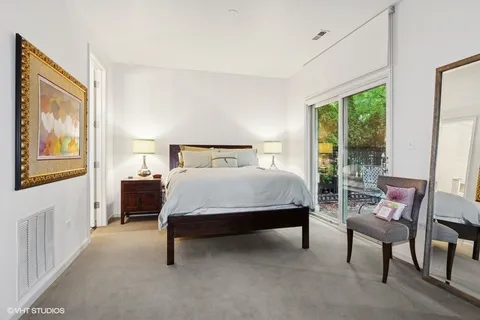 a bed room with a bed and a chair