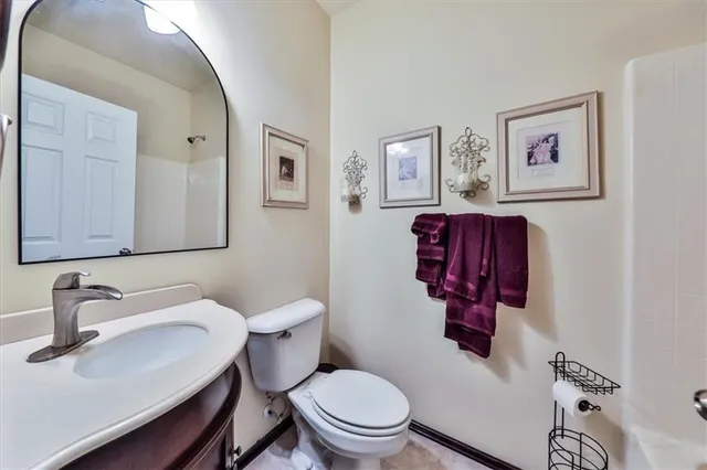 a living room with furniture a flat screen tv and a dining table