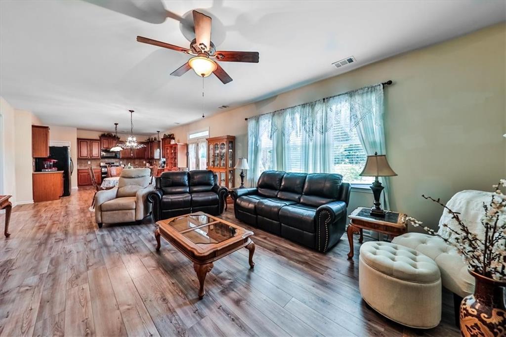 176 Oakland Way Dallas, GA 30157 - Photo 16 of 74 a living room with furniture or window and a wooden floor