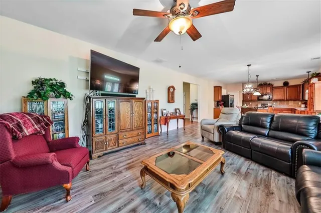 a large kitchen with stainless steel appliances granite countertop a stove and a wooden floors