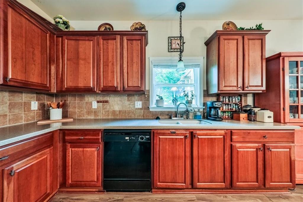 176 Oakland Way Dallas, GA 30157 - Photo 24 of 74 a kitchen with granite countertop a refrigerator and a sink