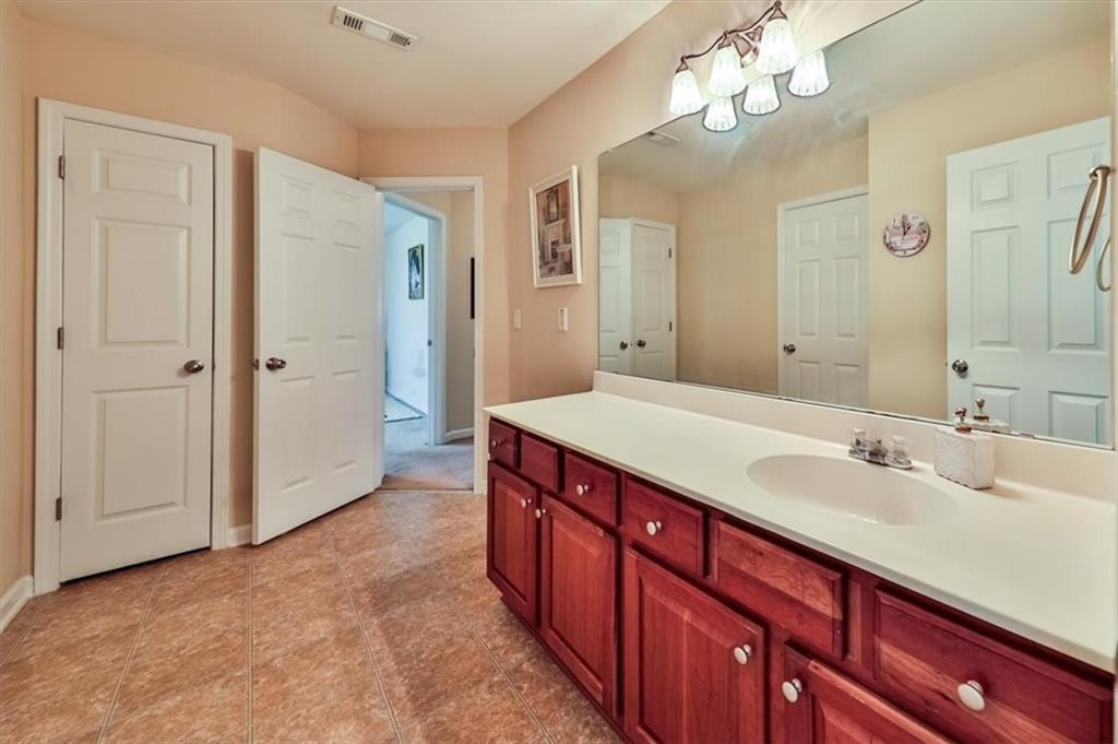 176 Oakland Way Dallas, GA 30157 - Photo 35 of 74 a spacious bathroom with a double vanity sink and a mirror