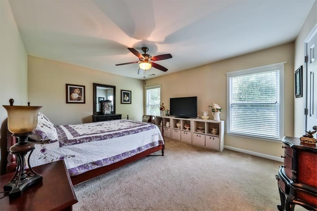 176 Oakland Way Dallas, GA 30157 - Photo 36 of 74 a bedroom with a bed and a flat screen tv