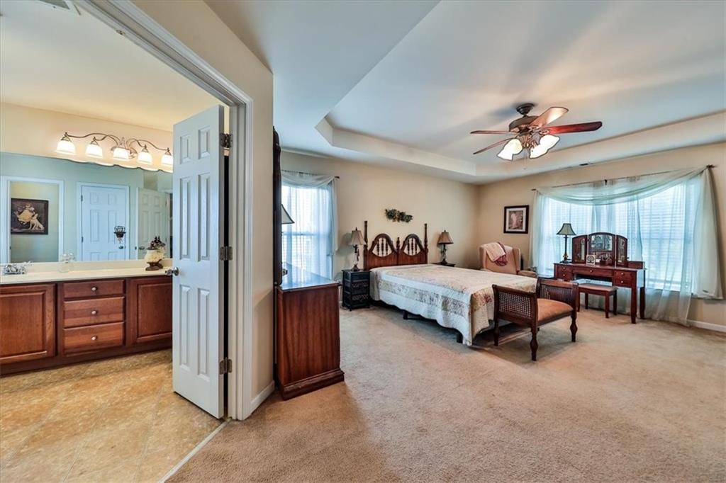 176 Oakland Way Dallas, GA 30157 - Photo 40 of 74 a bed room with furniture and a chandelier