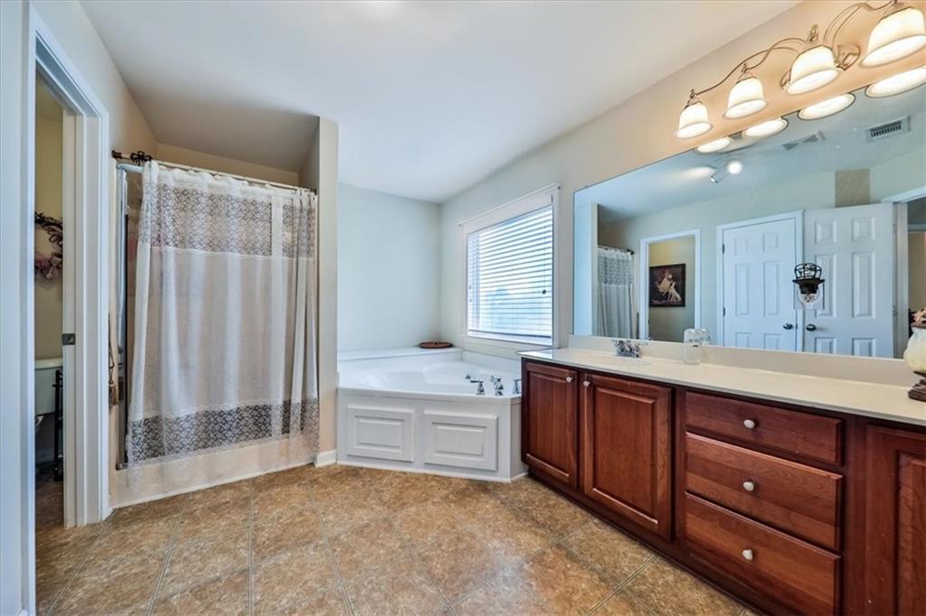 176 Oakland Way Dallas, GA 30157 - Photo 43 of 74 a spacious bathroom with a tub sink shower and mirror