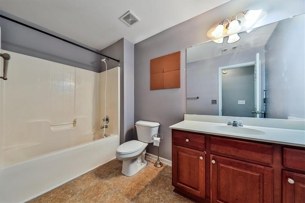 176 Oakland Way Dallas, GA 30157 - Photo 51 of 74 a spacious bathroom with a toilet sink and mirror