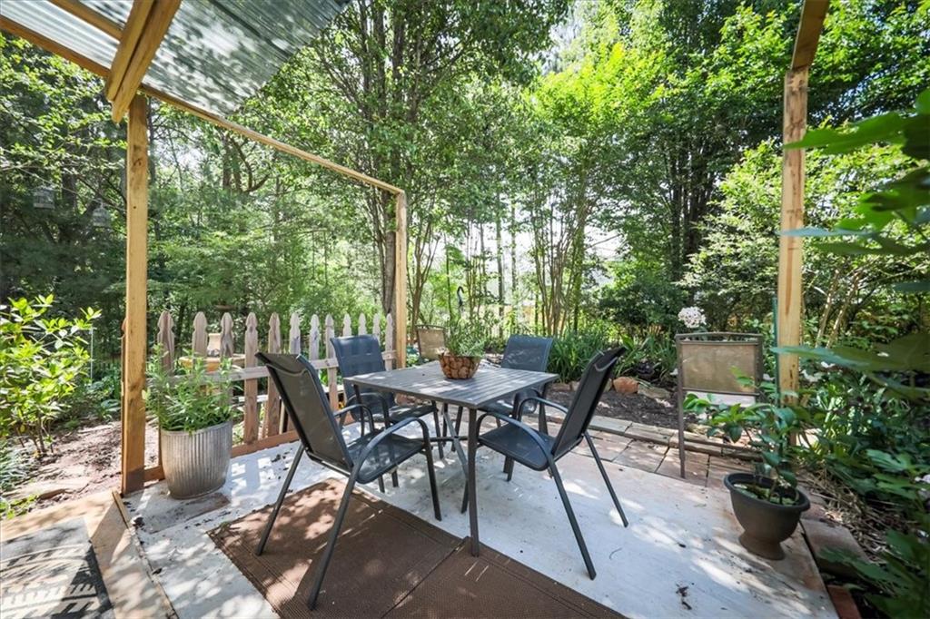 176 Oakland Way Dallas, GA 30157 - Photo 59 of 74 a view of a patio with table and chairs and potted plants