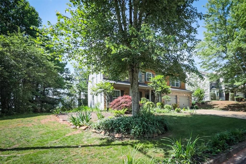 176 Oakland Way Dallas, GA 30157 - Photo 62 of 74 a view of a yard with plants and large trees