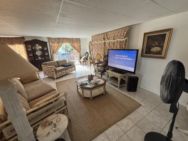 a kitchen with granite countertop a sink and a refrigerator