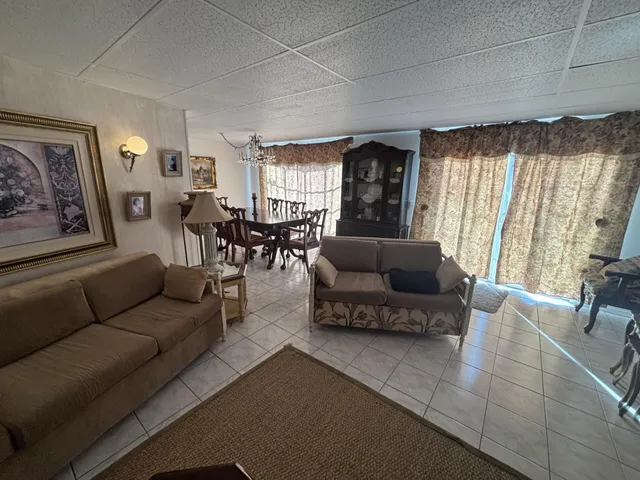 a kitchen with refrigerator and chairs
