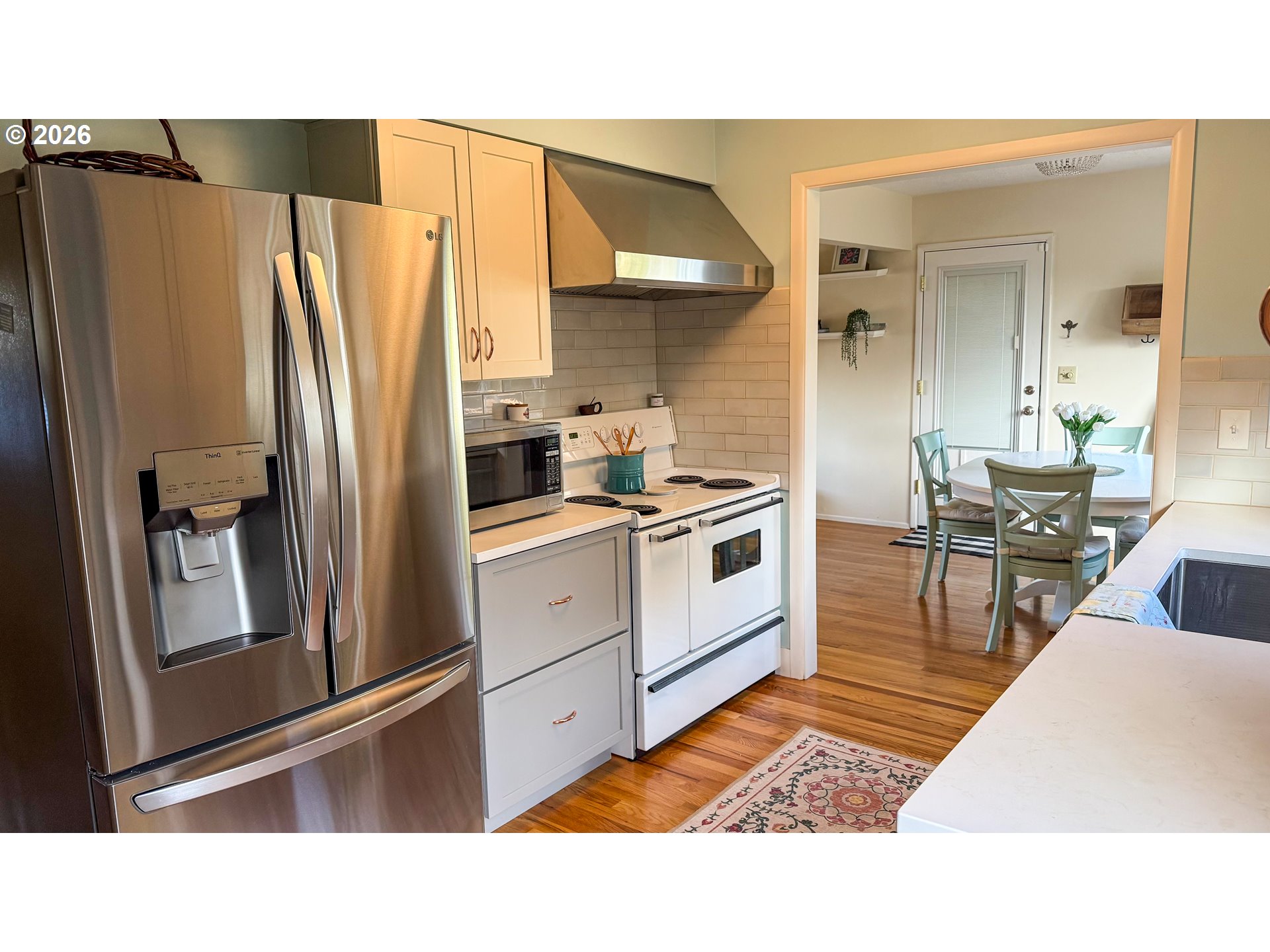 11734 Southeast Idleman Road Happy Valley, OR 97086 - Photo 11 of 48 a kitchen with stainless steel appliances kitchen island granite countertop a refrigerator and a stove