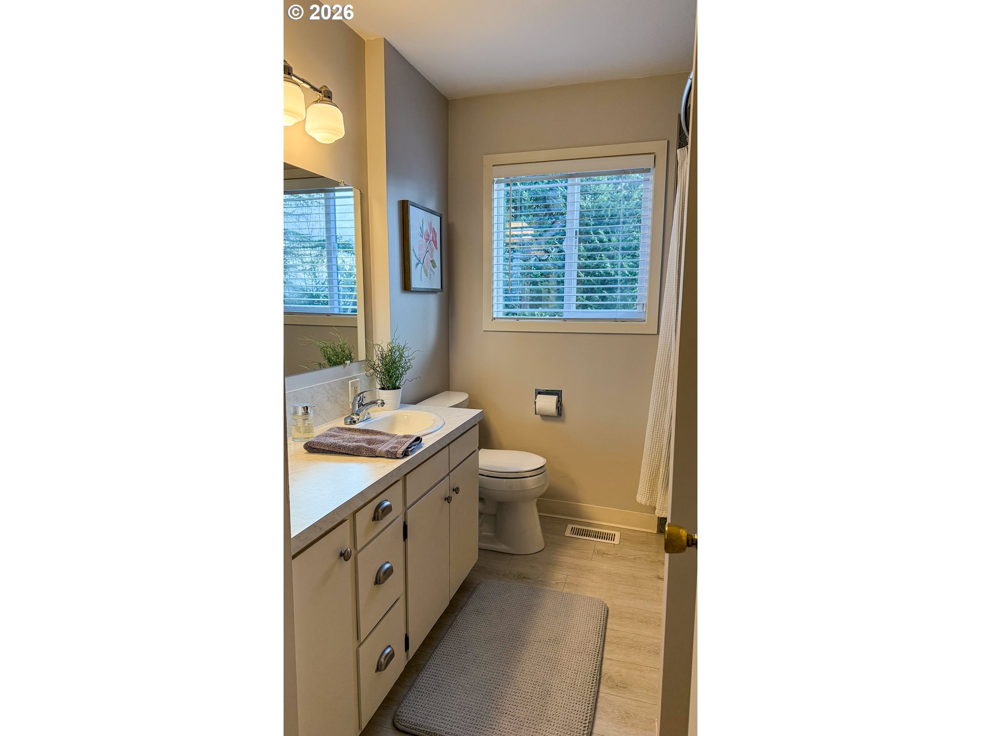 11734 Southeast Idleman Road Happy Valley, OR 97086 - Photo 18 of 48 a bathroom with a granite countertop toilet a sink and a mirror
