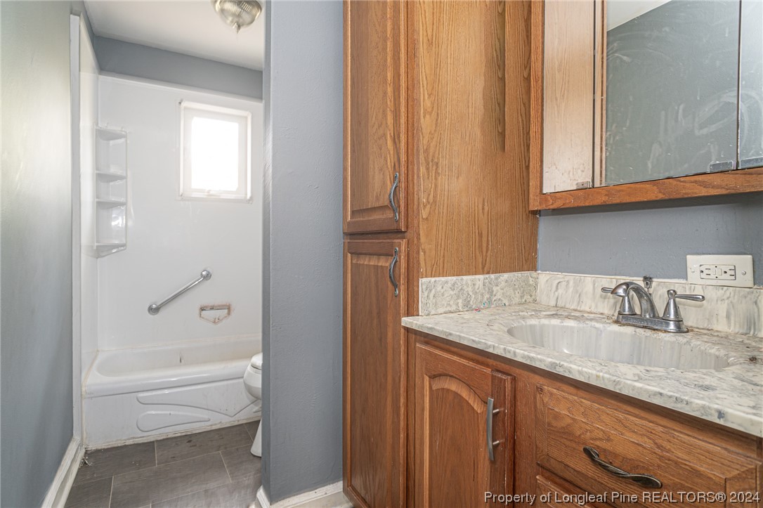 214 Lansdowne Road Fayetteville, NC 28314 - Photo 12 of 22 a bathroom with a granite countertop sink and a mirror