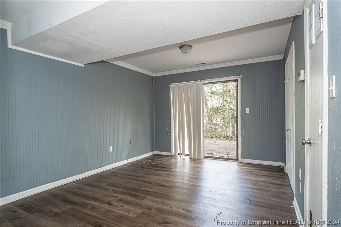 214 Lansdowne Road Fayetteville, NC 28314 - Photo 15 of 22 a view of an empty room with wooden floor and a window