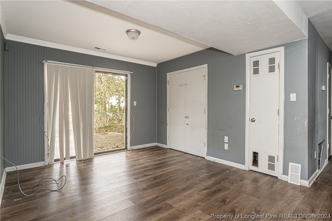 214 Lansdowne Road Fayetteville, NC 28314 - Photo 16 of 22 a view of an empty room with wooden floor and a window