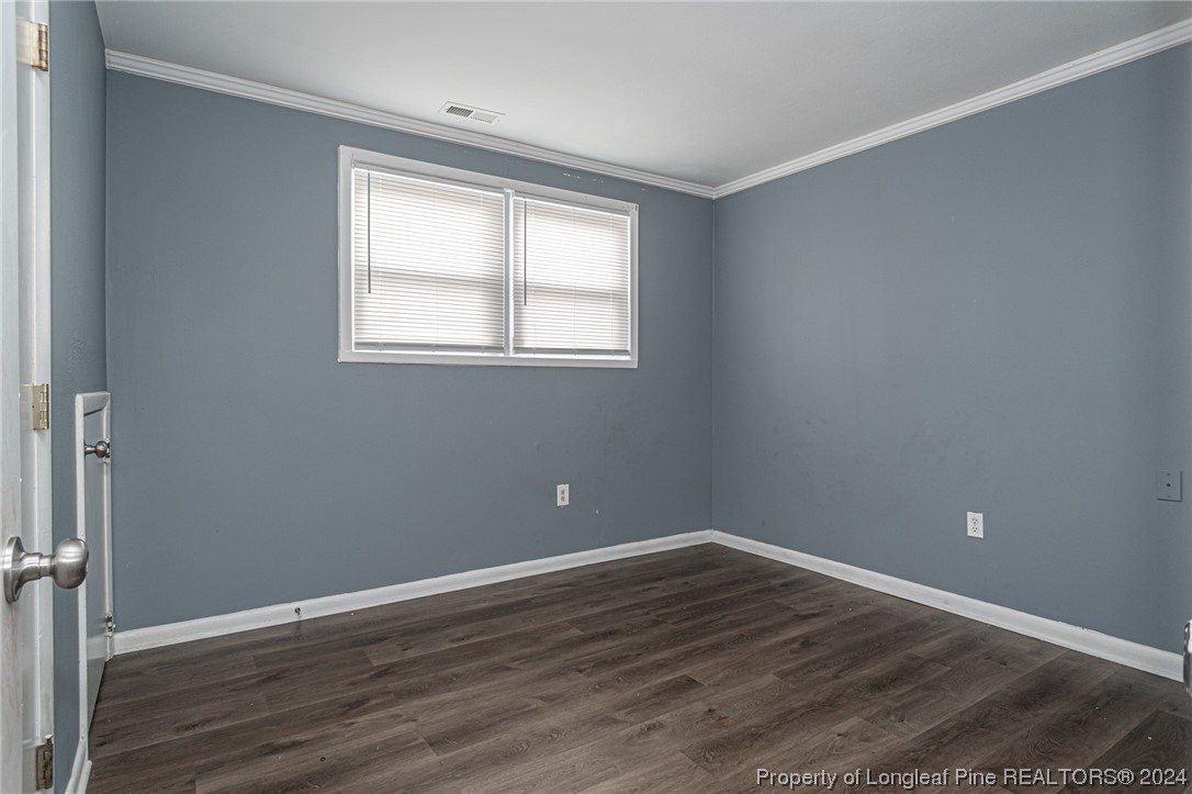 214 Lansdowne Road Fayetteville, NC 28314 - Photo 17 of 22 a view of an empty room with wooden floor and a window