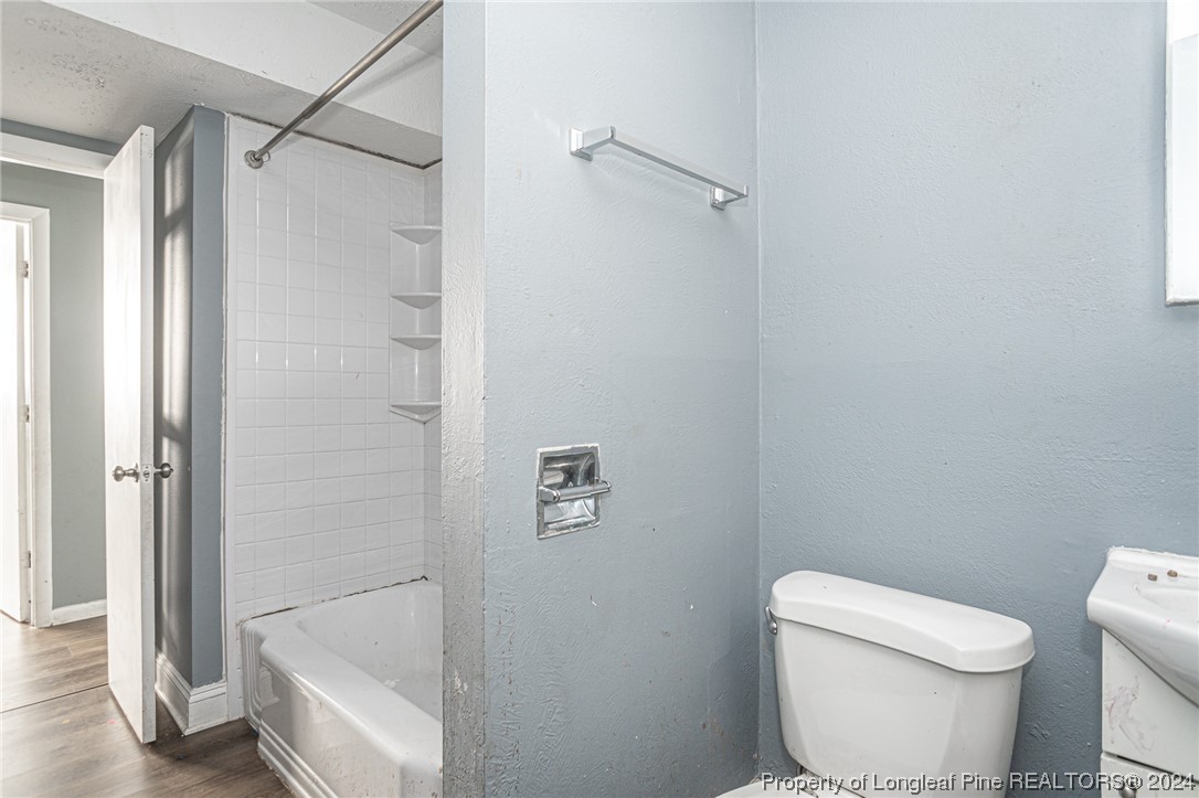 214 Lansdowne Road Fayetteville, NC 28314 - Photo 19 of 22 a white toilet sitting next to a shower