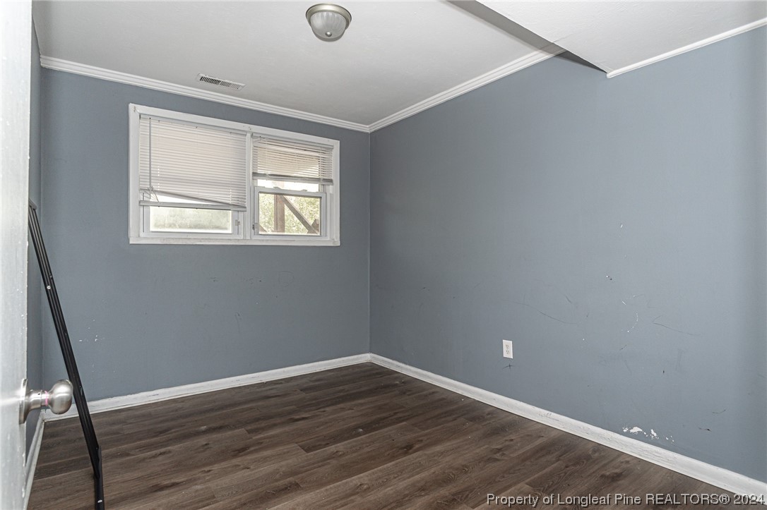 214 Lansdowne Road Fayetteville, NC 28314 - Photo 20 of 22 a view of an empty room with wooden floor and a window