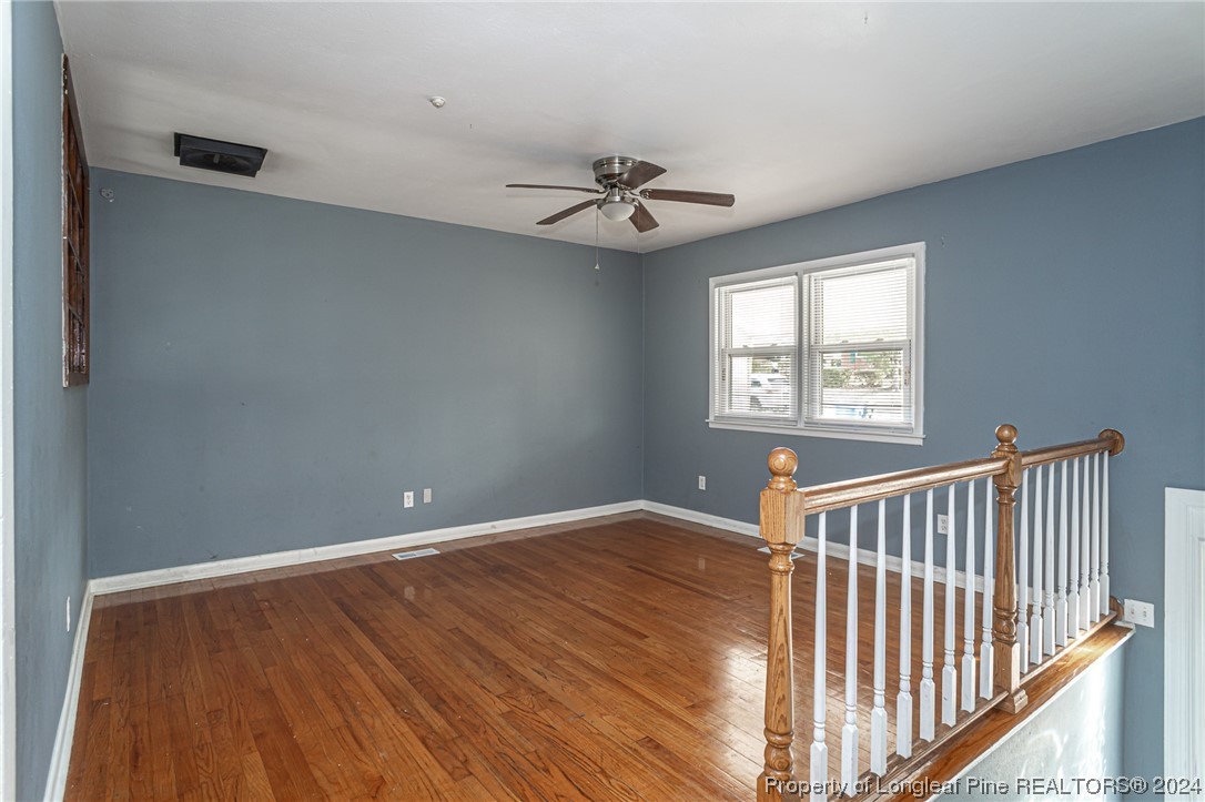 214 Lansdowne Road Fayetteville, NC 28314 - Photo 5 of 22 an empty room with windows and ceiling fan