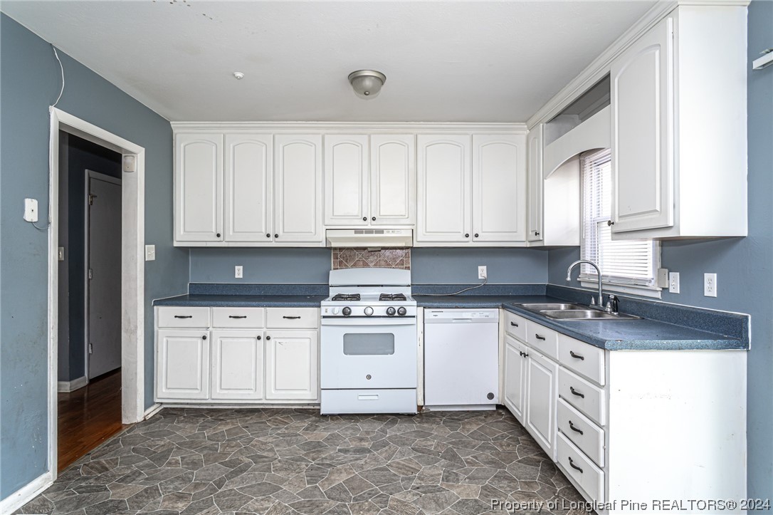 214 Lansdowne Road Fayetteville, NC 28314 - Photo 8 of 22 a white kitchen with granite top and stainless steel appliances
