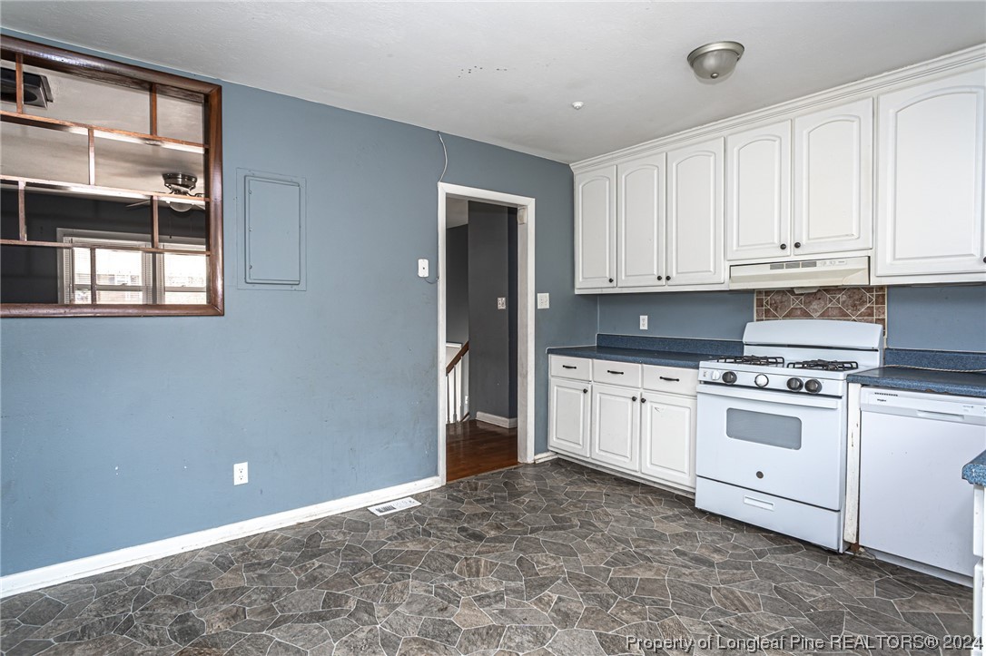 214 Lansdowne Road Fayetteville, NC 28314 - Photo 10 of 22 a kitchen with granite countertop white cabinets and white appliances
