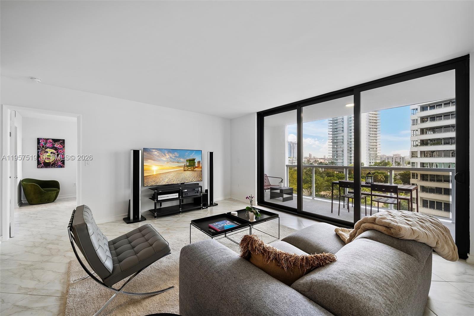 9 Island Avenue, Unit 710 Miami Beach, FL 33139 - Photo 1 of 15 a living room with furniture and a flat screen tv
