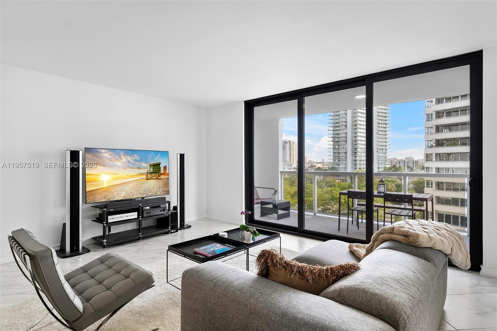 9 Island Avenue, Unit 710 Miami Beach, FL 33139 - Photo 15 of 15 a living room with furniture and a flat screen tv