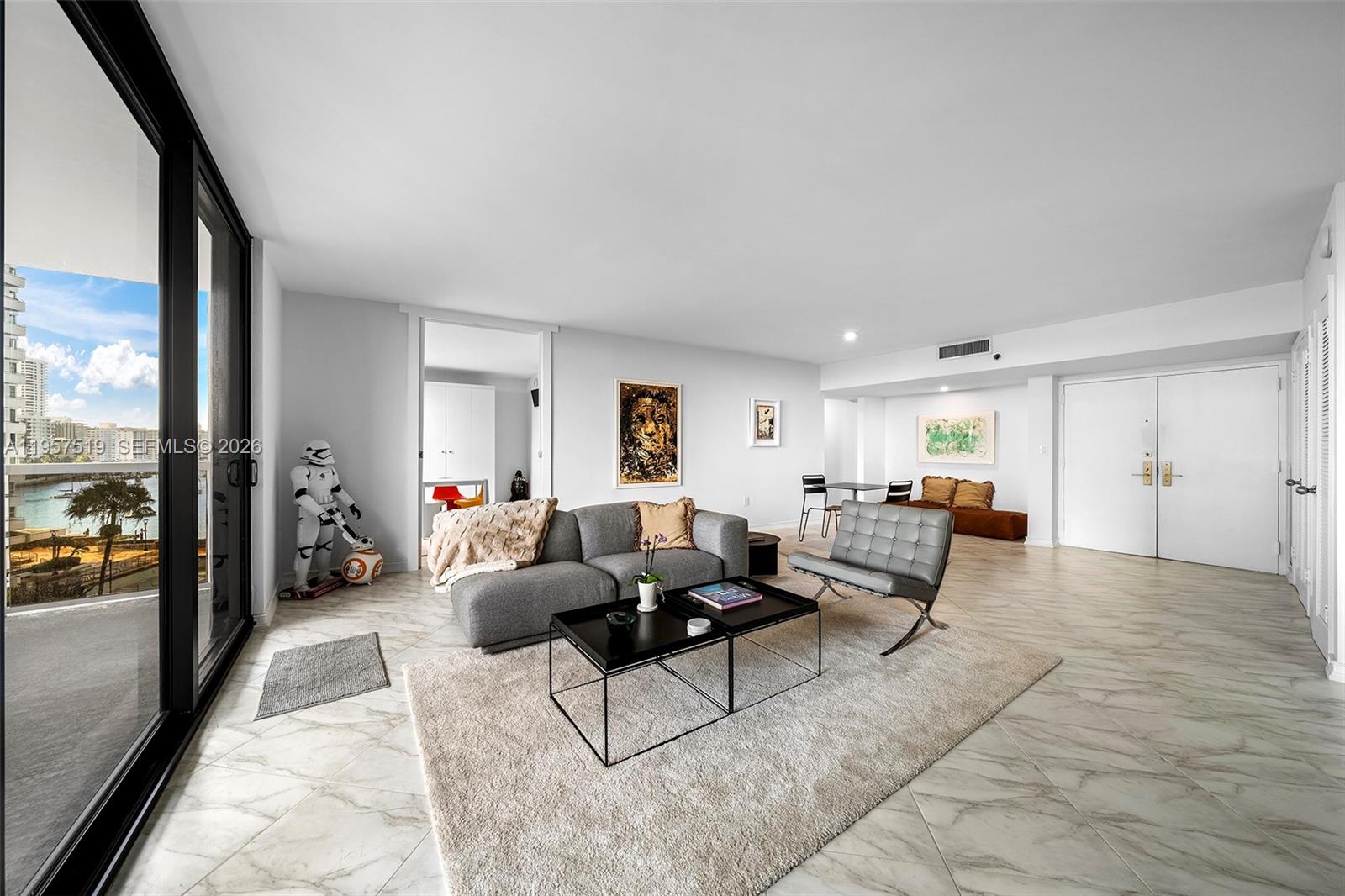 9 Island Avenue, Unit 710 Miami Beach, FL 33139 - Photo 3 of 15 a living room with furniture and a large window