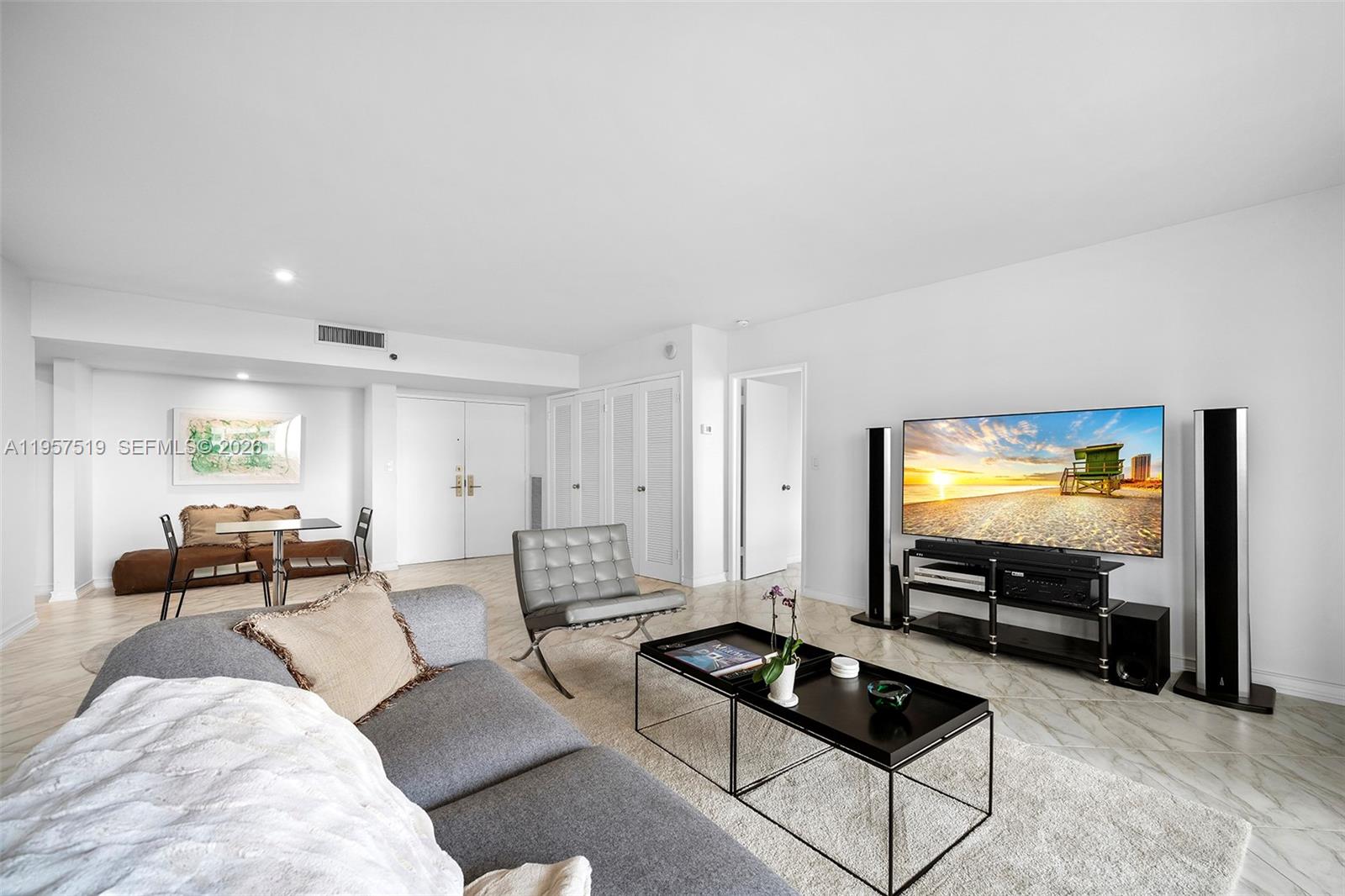 9 Island Avenue, Unit 710 Miami Beach, FL 33139 - Photo 4 of 15 a living room with furniture and a flat screen tv