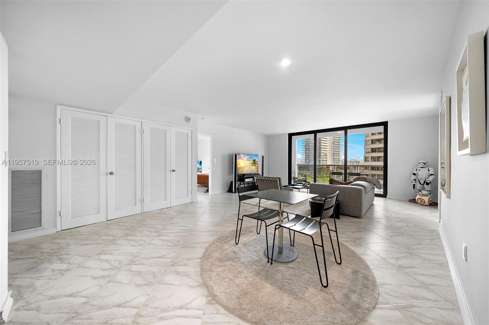 9 Island Avenue, Unit 710 Miami Beach, FL 33139 - Photo 5 of 15 a living room with furniture and a flat screen tv
