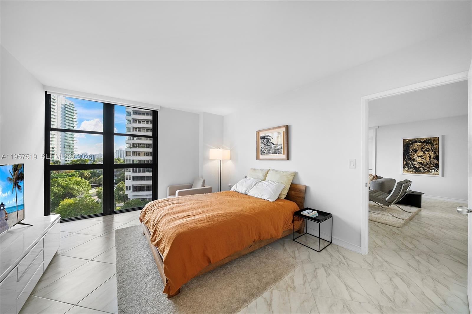 9 Island Avenue, Unit 710 Miami Beach, FL 33139 - Photo 7 of 15 a bedroom with a bed and a large window
