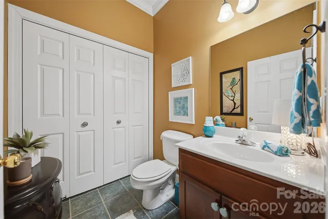 a bathroom with a sink toilet and mirror