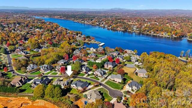 a living room filled with furniture and large windows