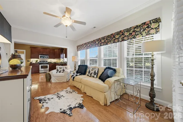 a living room with furniture and a floor to ceiling window