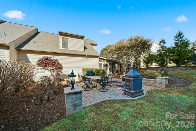 a view of a house with backyard sitting area and garden