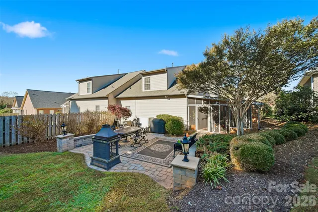 a view of a house with a yard and sitting area