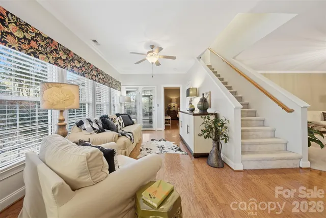 a living room with furniture a fireplace and a chandelier