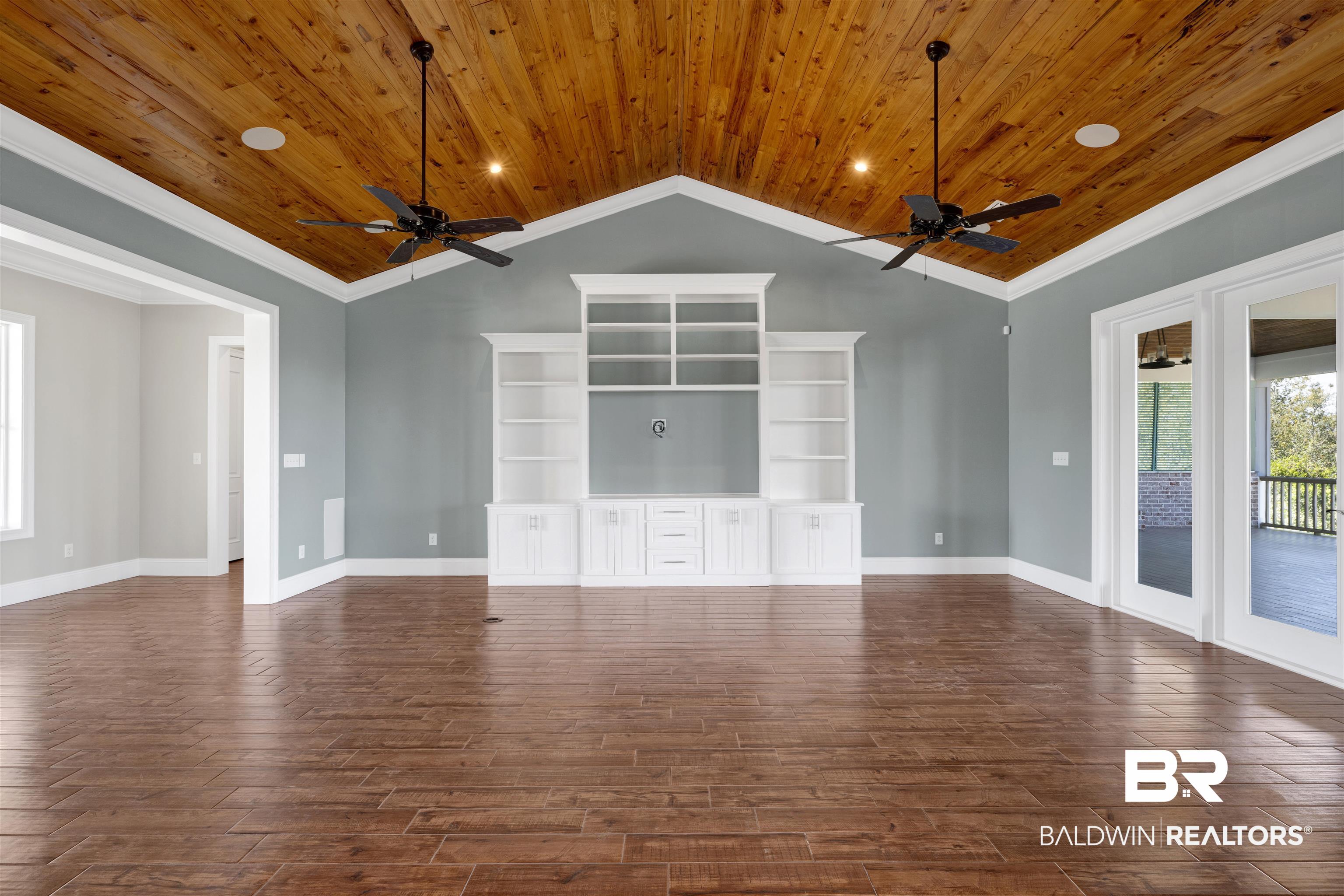 31729 River Road Orange Beach, AL 36561 - Photo 9 of 54 Unfurnished living room with a ceiling fan, wood finish floors, ornamental molding, wooden ceiling, and recessed lighting