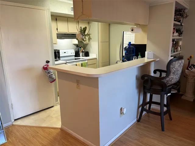 a kitchen with stainless steel appliances granite countertop a sink and a refrigerator