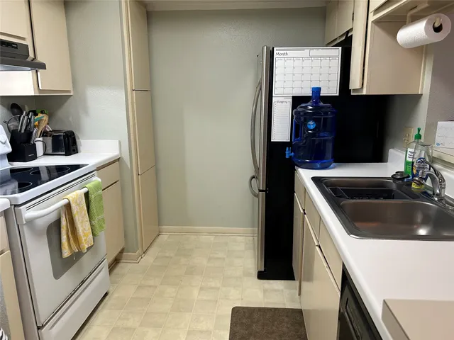 a kitchen with a sink and a stove top oven