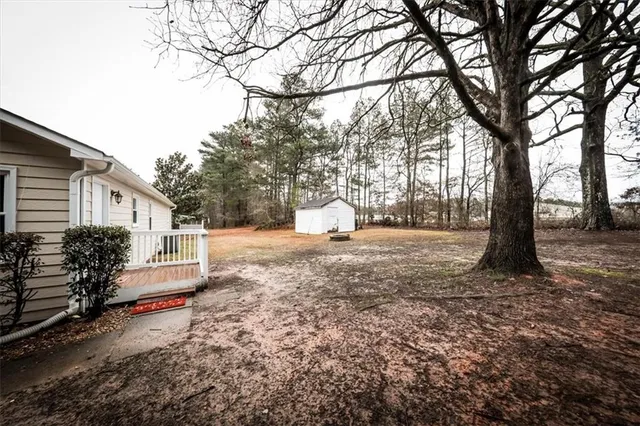 a view of a house with a yard and sitting area