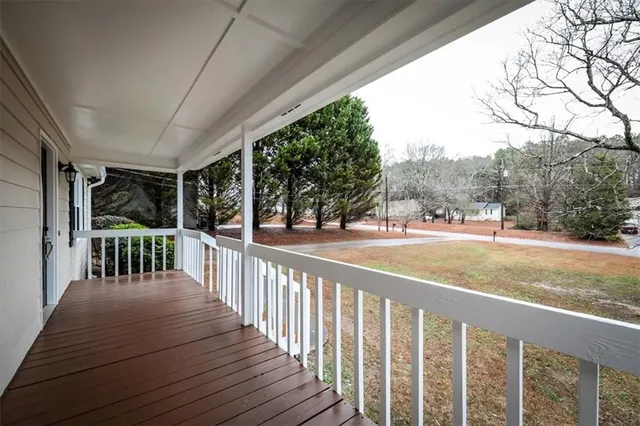 wooden floor fireplace and windows in an empty room