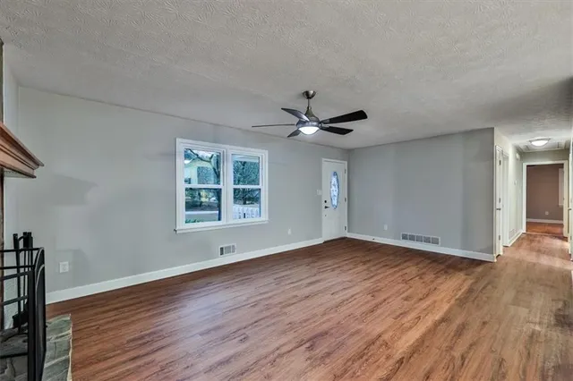 a large kitchen with granite countertop a sink and cabinets