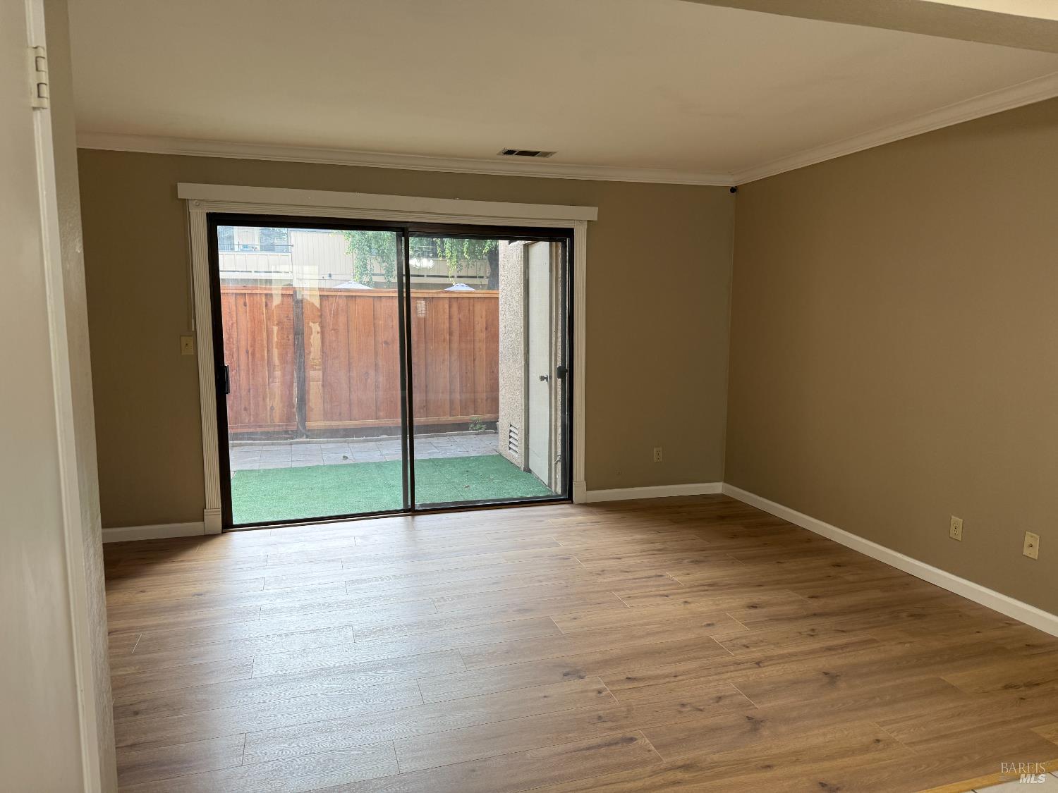 2161 Northwood Circle, Unit C Concord, CA 94520 - Photo 11 of 19 a view of an empty room with wooden floor and a window