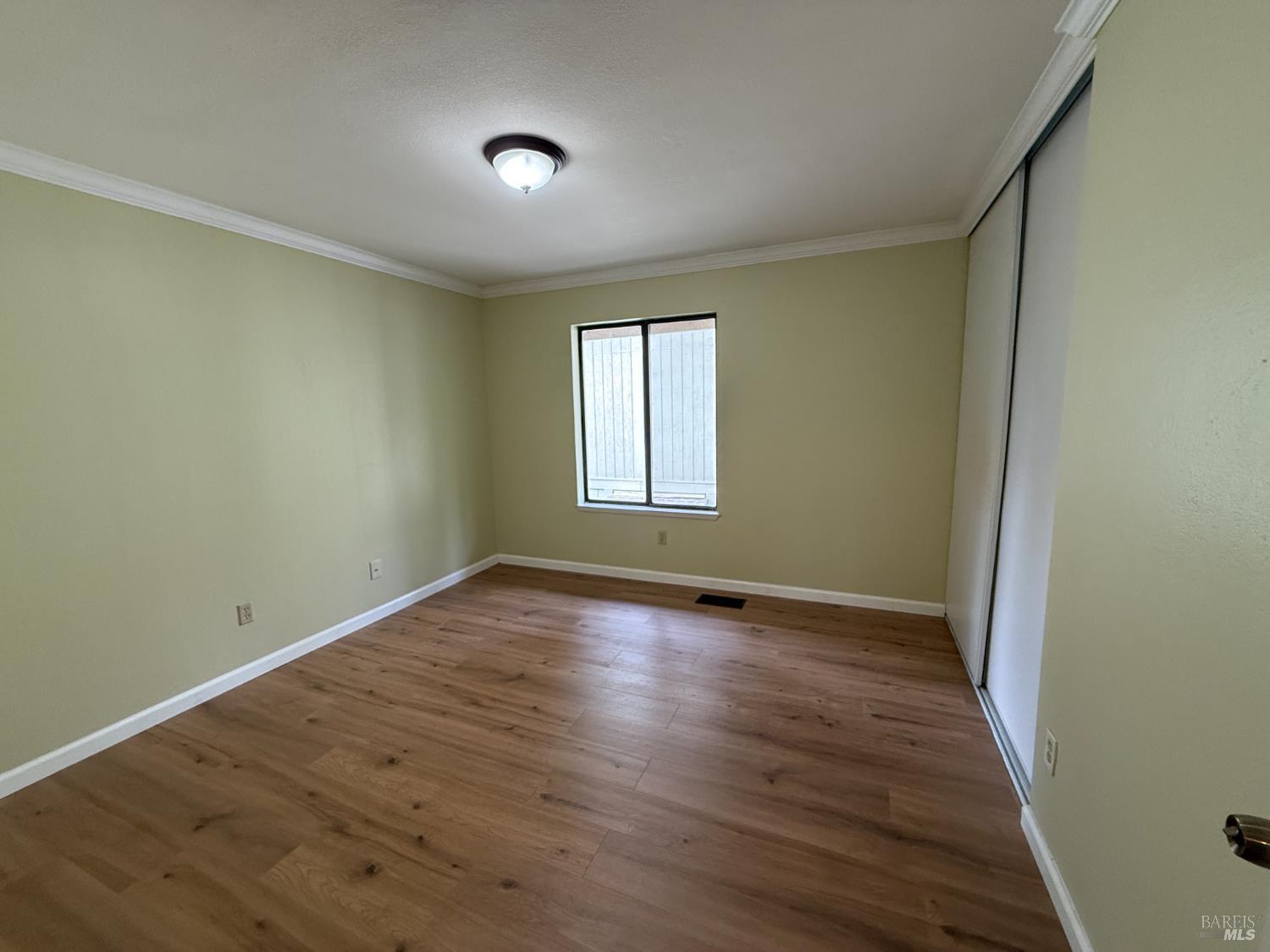 2161 Northwood Circle, Unit C Concord, CA 94520 - Photo 13 of 19 an empty room with wooden floor and windows