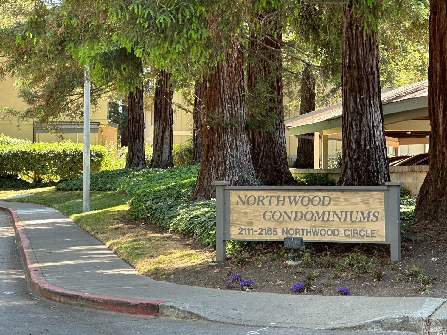 2161 Northwood Circle, Unit C Concord, CA 94520 - Photo 2 of 19 a view of outdoor space with sign board tree and wooden fence