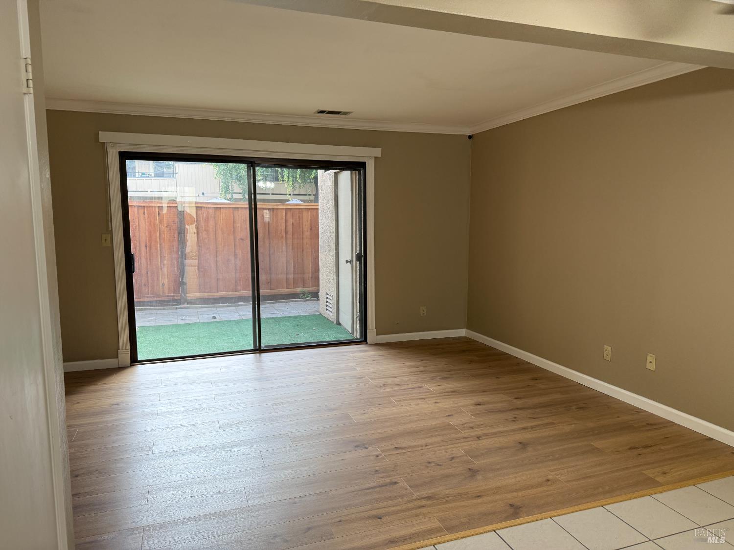 2161 Northwood Circle, Unit C Concord, CA 94520 - Photo 5 of 19 a view of an empty room with wooden floor and a window