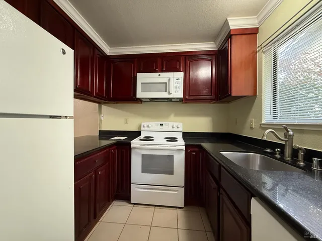 a kitchen with a sink stove and microwave