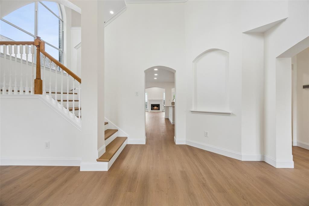 819 Kipling Drive Allen, TX 75002 - Photo 2 of 29 a view of a hallway with wooden floor and staircase