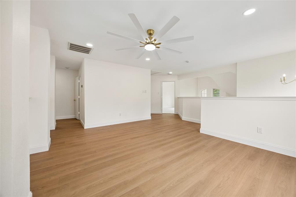 819 Kipling Drive Allen, TX 75002 - Photo 22 of 29 a view of an empty room with wooden floor and a ceiling fan